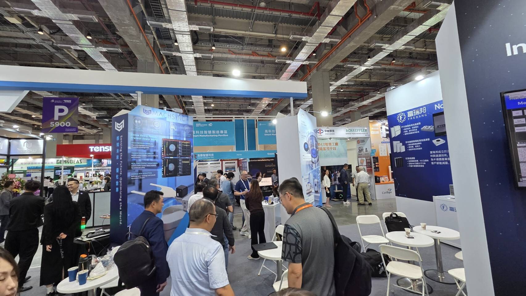 Visitors and team members in conversation at the WANTEC booth